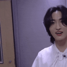 a close up of a person wearing a white shirt and earphones .