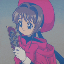 a girl in a red hat is holding a card and giving a peace sign