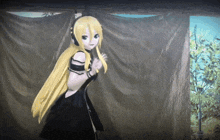 a girl with long blonde hair and headphones stands in front of a curtain