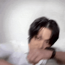 a blurry picture of a man taking a selfie with his phone .