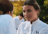 a woman wearing a white coat with the number 41 on the front