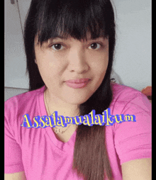 a woman in a pink shirt with the words assalamualaikum