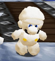 a white stuffed animal with blue eyes and a yellow waistband
