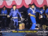 a group of people are dancing on a stage with the name david fahrulloh written on the bottom