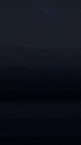 a purple fireworks display in the dark with a dark background