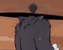tom and jerry are standing next to each other in a cartoon and tom is holding a sword .