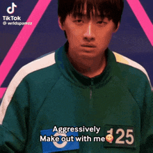 a man in a green jacket with the number 125 on it