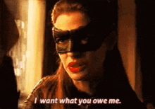 a woman wearing a mask is talking to another woman .