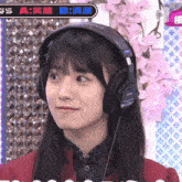 a girl wearing a pair of sony headphones is smiling