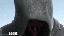 a close up of a person wearing a hooded jacket with the word adobe written on the bottom .