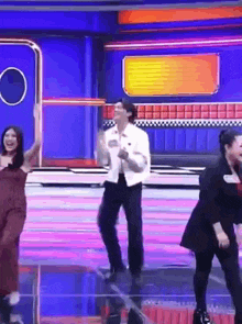 a group of people are dancing on a stage in front of a camera .