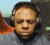 a man wearing headphones with his eyes closed .