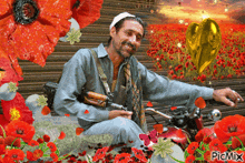 a man is sitting on a motorcycle in a field of red flowers with a picmix watermark
