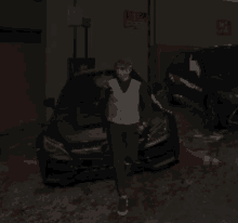 a man walking in front of a car with a no parking sign