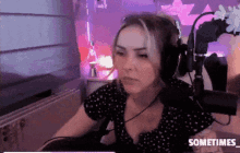 a woman wearing headphones is sitting in front of a microphone and the words sometimes are on the bottom of the screen