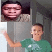 a boy in a green shirt is smiling in front of a man in a black hat