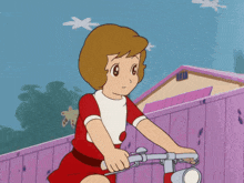 a girl in a red dress is riding a bicycle in front of a brick wall