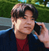 a man in a blue jacket is talking on a cellphone