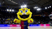 a mascot on a basketball court with a banner that says prime on it