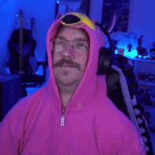 a man wearing a flamingo hoodie and glasses