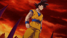 a cartoon character named goku is standing in front of a red background