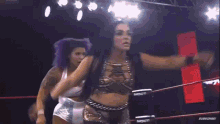 two women are wrestling in a ring with the words impact on the screen