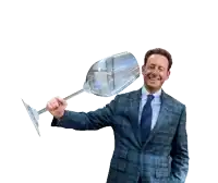 a man in a suit and tie is holding a large glass