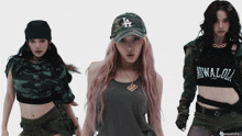 a woman wearing a la hat is standing next to two other girls