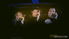 three men are sitting in the back seat of a car with gifrun.com written on the bottom