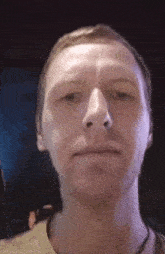 a close up of a man 's face with a beard and a nose .