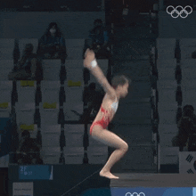 a woman in a red bikini is diving into a pool