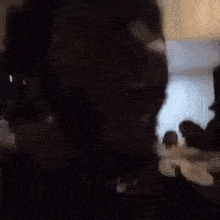 a man 's face is visible in a blurry photo while a group of people are standing in the background .