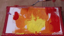 a person is painting on a piece of paper with a brush and the words made in animatica on the bottom
