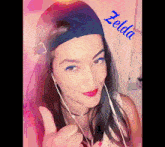 a woman wearing headphones and a hat with the name zelda written on it