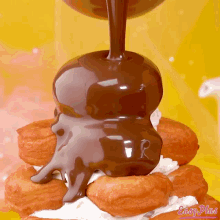 a stack of donuts with chocolate being poured on top and easy plus written on the bottom right