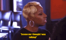 a woman says " excuse me i thought i was talking " while wearing hoop earrings