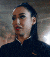 a close up of a woman 's face with red lipstick and a black jacket .