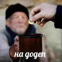 a person is putting a coin into a cup with the words ha gogen written below it