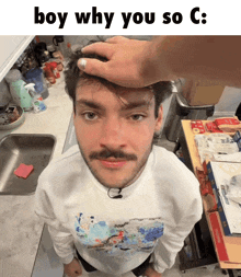 a man with a mustache is getting his head rubbed by another man