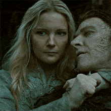 a woman holds a knife to a man 's throat