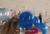 a group of people holding blue balloons with the words " this is 30 fucking 30 " on the bottom