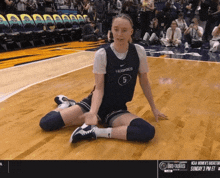 a girl in a huskies jersey sits on the court