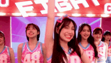 a group of cheerleaders wearing number 48 uniforms