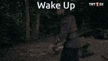 a man is holding an axe in the woods and the words wake up are on the screen