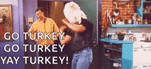 a man with a turkey on his head is dancing in a kitchen with two men .