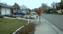 a person in an elf costume is running down a sidewalk
