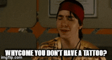 a woman in a gold shirt is asking why come you don 't have a tattoo .