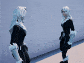 a woman in a black and white costume is standing next to another woman in a black and white costume