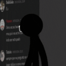 a silhouette of a person standing in front of a wall with a blurred image of a person 's face