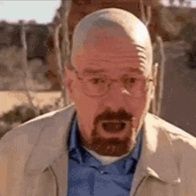 a bald man with a beard and glasses is making a surprised face .